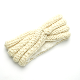 A handmade Veronica Headband on a white surface.