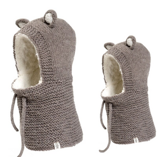 Two handmade knitted Teddy Hood bear hats on a white background.