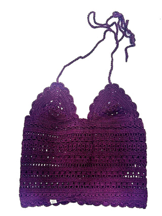 Part of the summer collection from Nirvanna Designs, the Classic Top is a purple crochet halter with scalloped edges, tie-neck strap, and intricate see-through patterns. It’s shown laid flat on a white background.