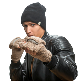 A person wearing a black beanie, a black leather jacket, and beige Fingerless Gloves With Button Flap and Fleece Lining is posed with their gloved fists raised, suggesting a defensive or playful stance. The background is white.