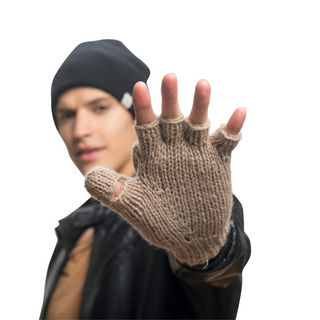 A person wearing a black beanie, black leather jacket, and beige Fingerless Gloves with Button Flap and Fleece Lining is extending their gloved hand towards the camera in a stop gesture. Their face is slightly out of focus while the glove is clearly in focus.