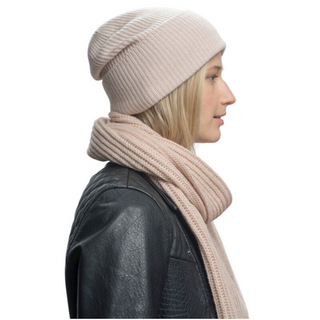 A woman wearing a pink handmade Laurent Scarf and leather jacket.