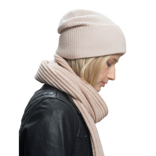 A woman wearing a pink Laurent Scarf and leather jacket.