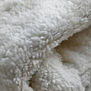 Close-up view of the Ryan Handwarmers' soft, white fabric featuring a fluffy, fleece-like texture made of small, dense fibers for a cozy and plush look.