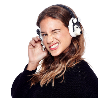A woman wearing Wolf Earmuffs and a hand-knit black sweater.