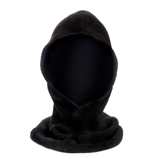 The Roll Hood is a black wool hooded garment with no visible face or features, draping loosely and handmade in Nepal from textured fabric. It is photographed against a white background.